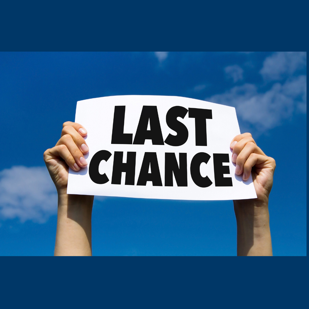Hands holding a Last Chance sign