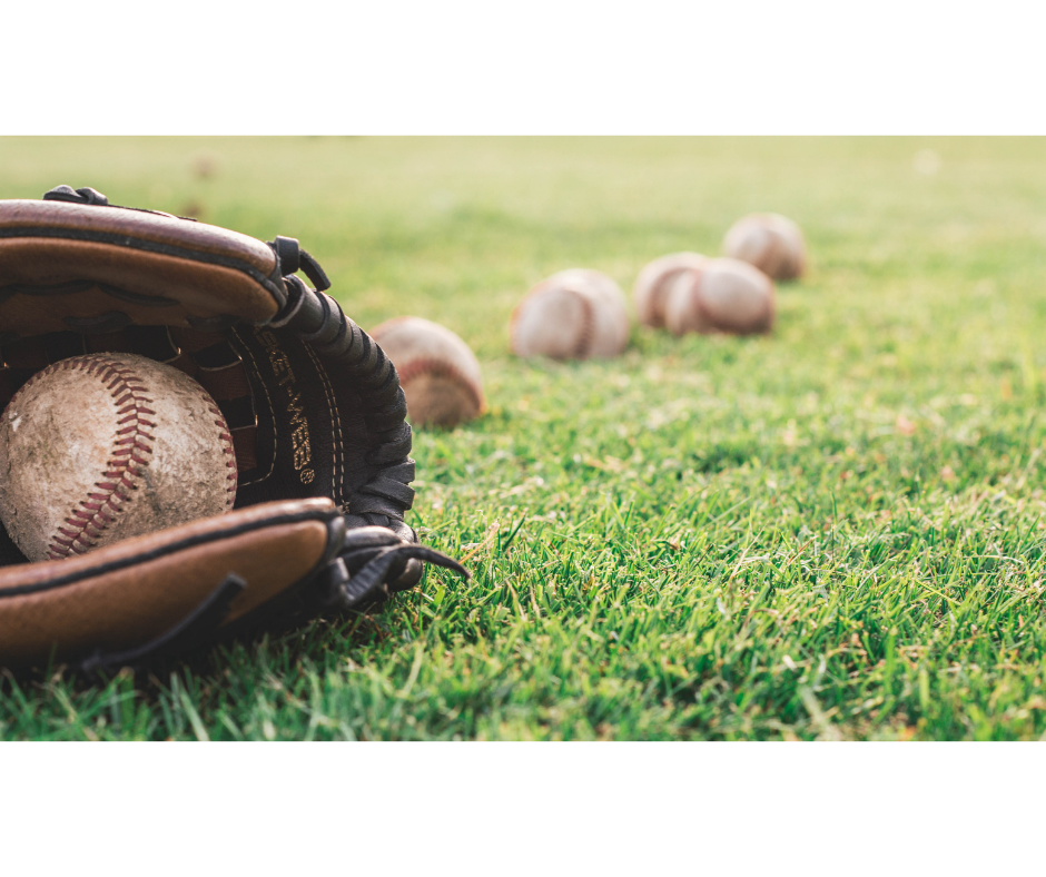 Baseball glove and baseballs on grass