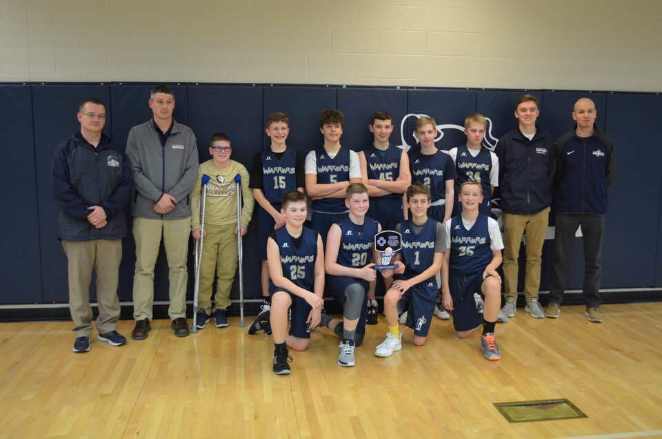 Boys basketball team with tournament trophy